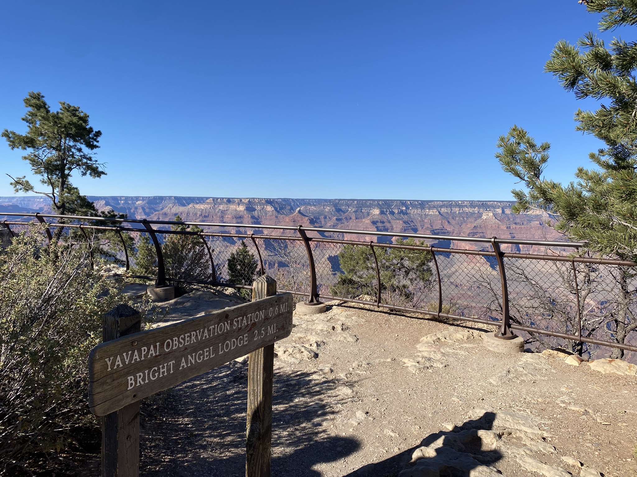 Photo of the Grand Canyon in Arozona from the South Rim, showing a sign for a nearby outpost.