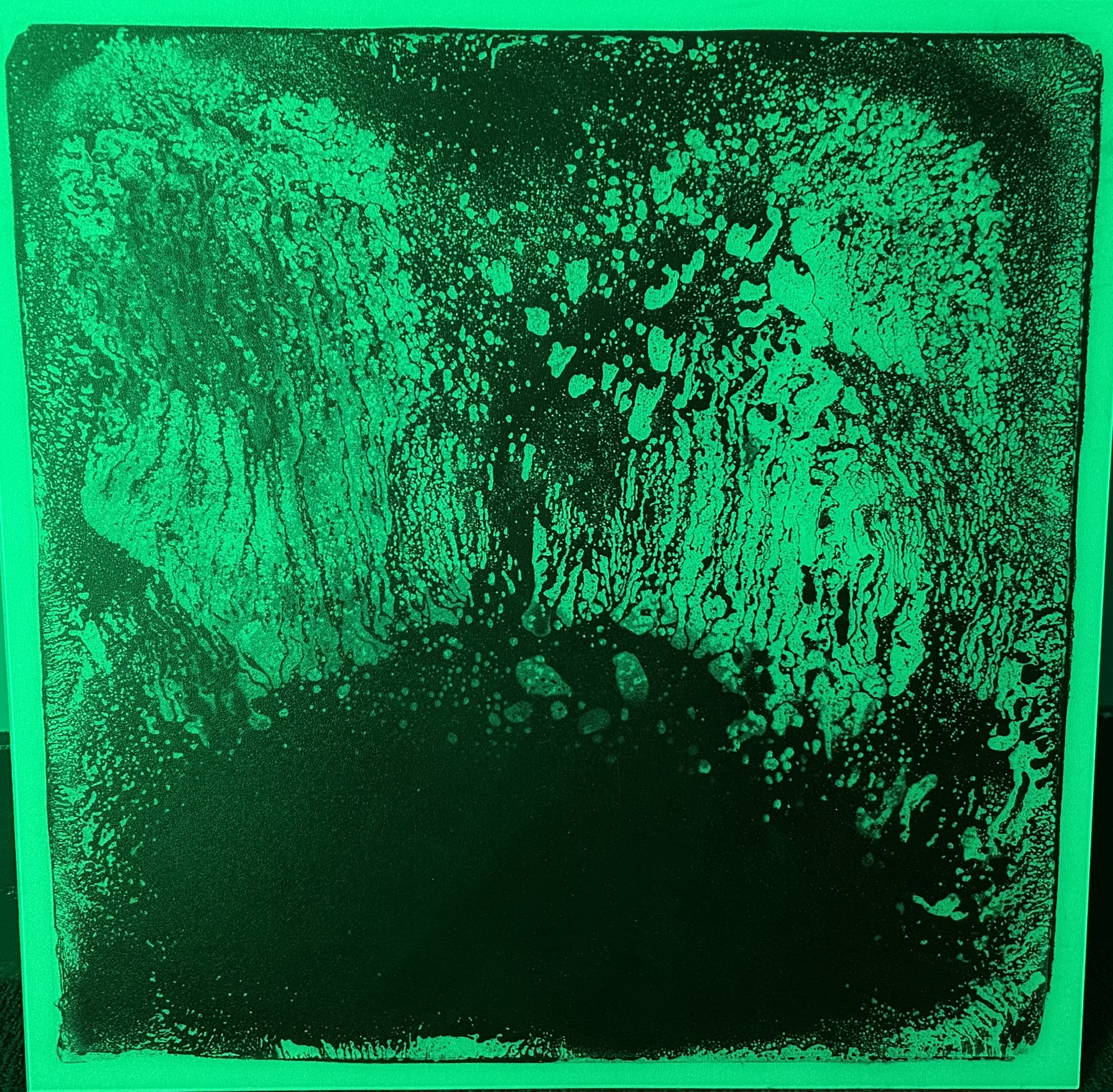 Photo of a cool looking sensory gel tile lit up in green light.